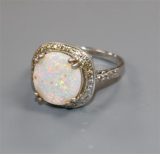 A 9ct white gold, white opal and diamond cluster ring, size O.